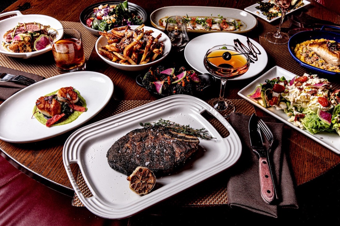 A steakhouse spread with dry-aged steak and sides